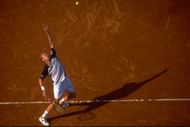 Marc Rosset prepares to serve on clay